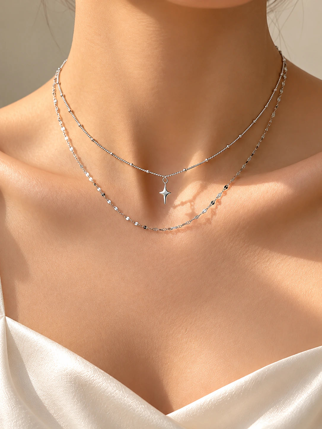 Silver star pendant two-layer necklace on model in sunlight | SKREAM