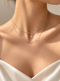 Minimal silver double chain star necklace worn close-up | SKREAM