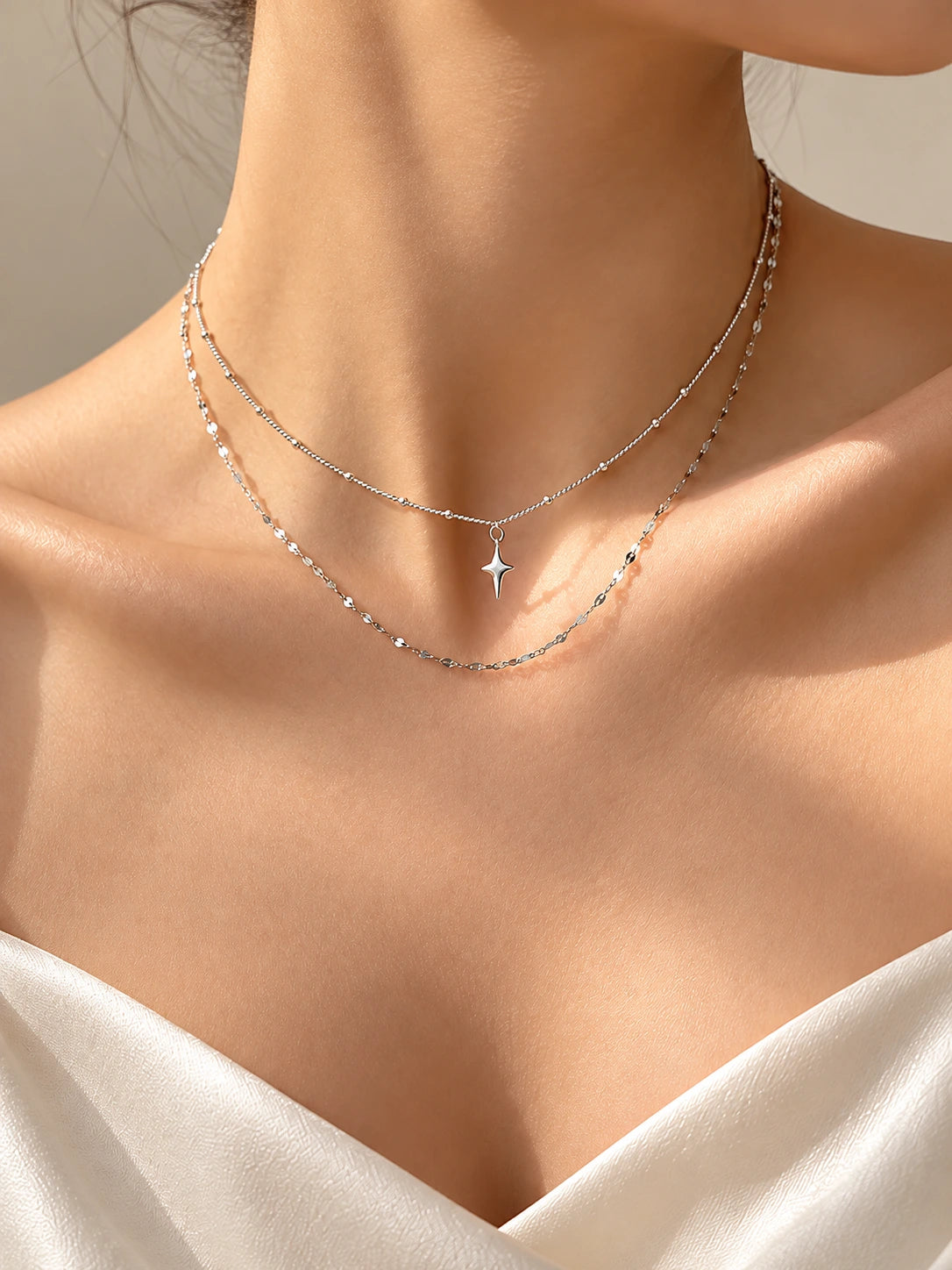 Minimal silver double chain star necklace worn close-up | SKREAM